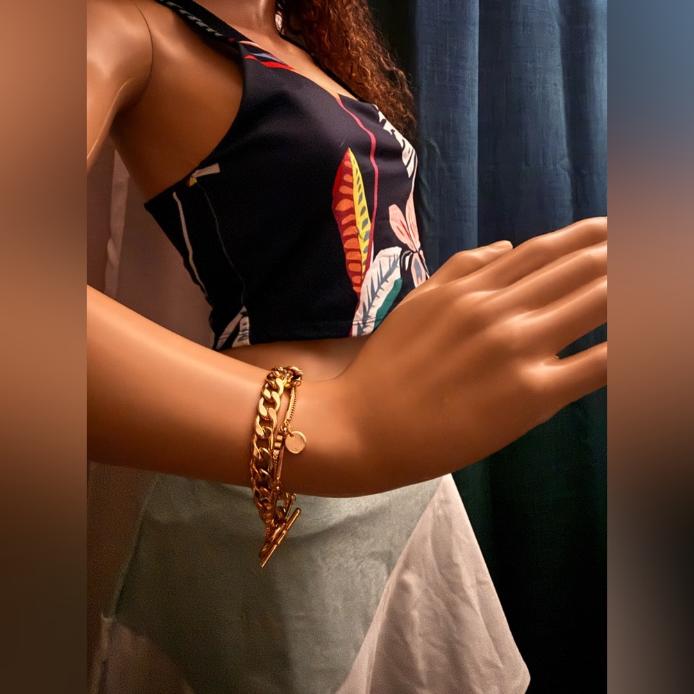 Bracelet gold-tone layered chain bracelet with a toggle clasp.